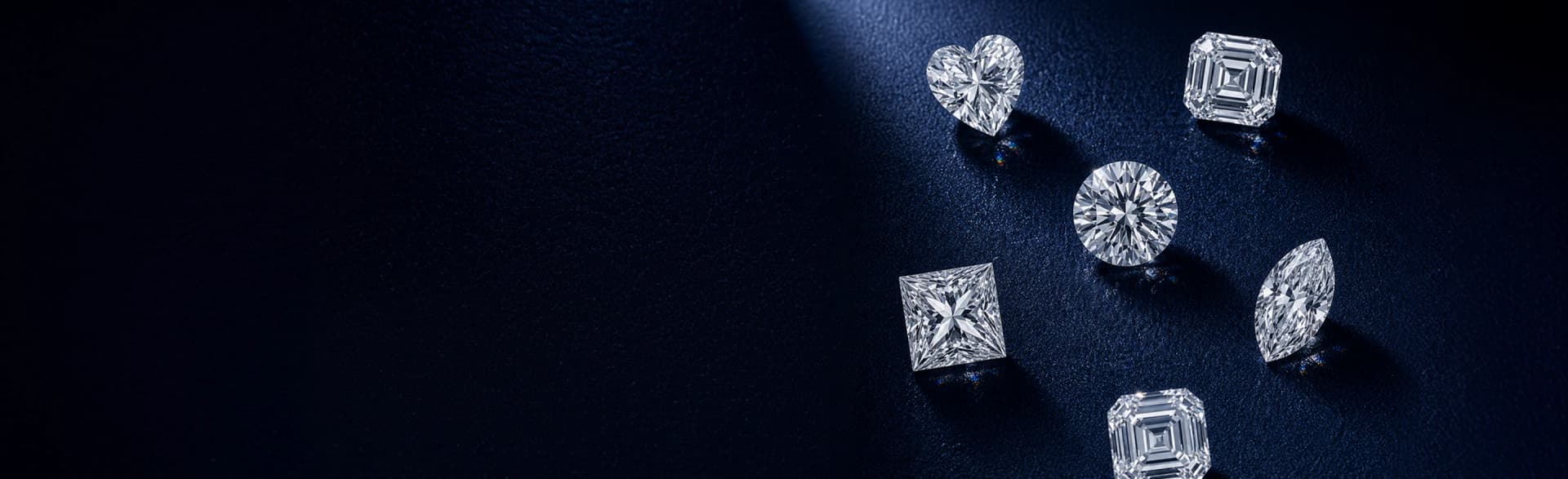 Loose diamonds scattered on dark surface